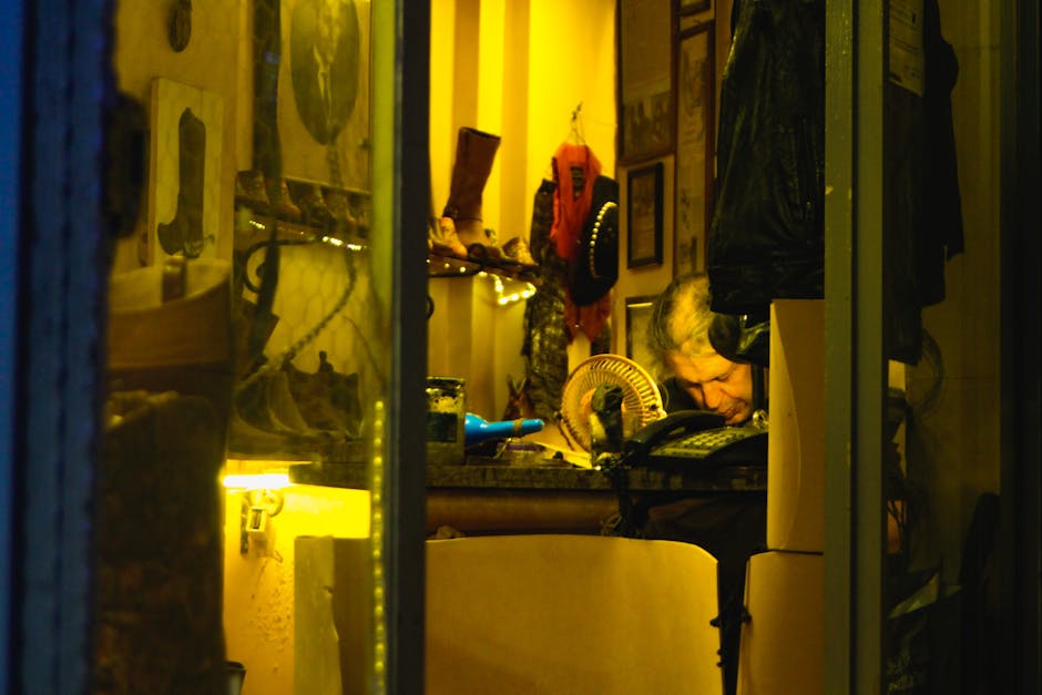 A quaint shoe repair shop with a craftsman focused on his work under warm lighting.