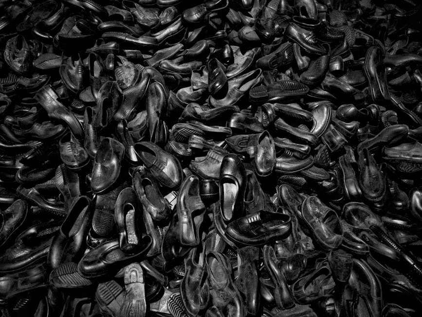 Monochrome image of a large pile of vintage shoes, creating an abstract texture.